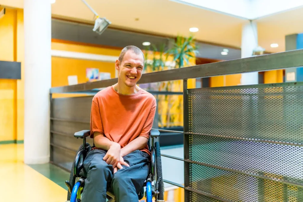 Disabled man in wheelchair smiling at camera