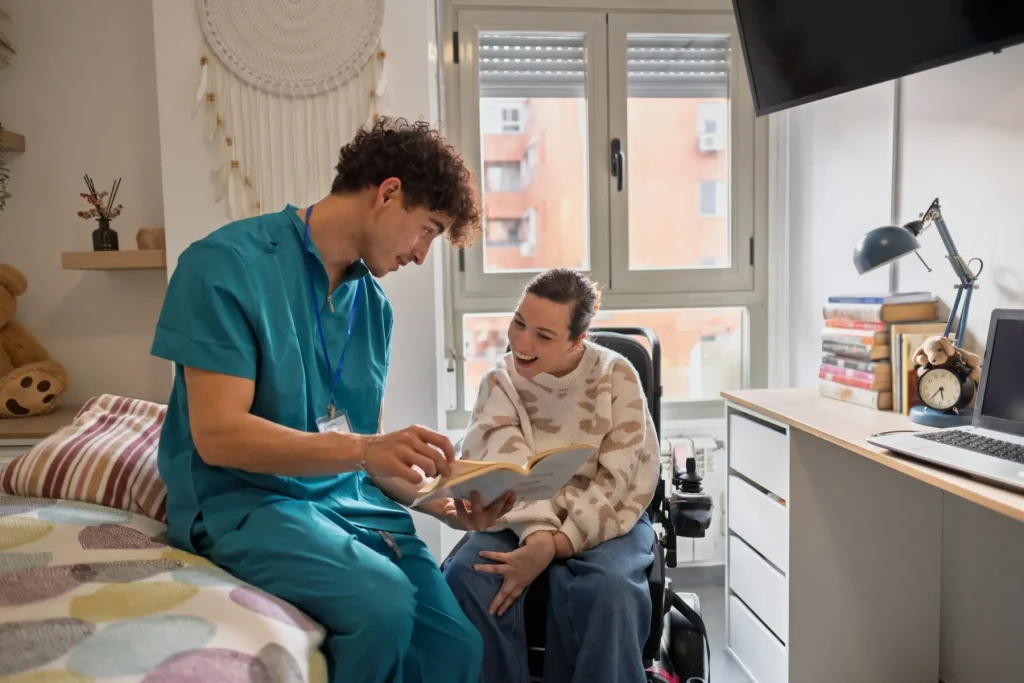 Support worker and disabled woman in wheelchair talking