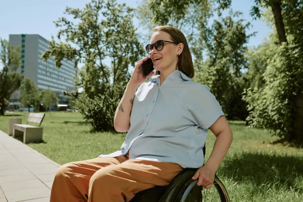 Disabled woman in wheelchair making phone call